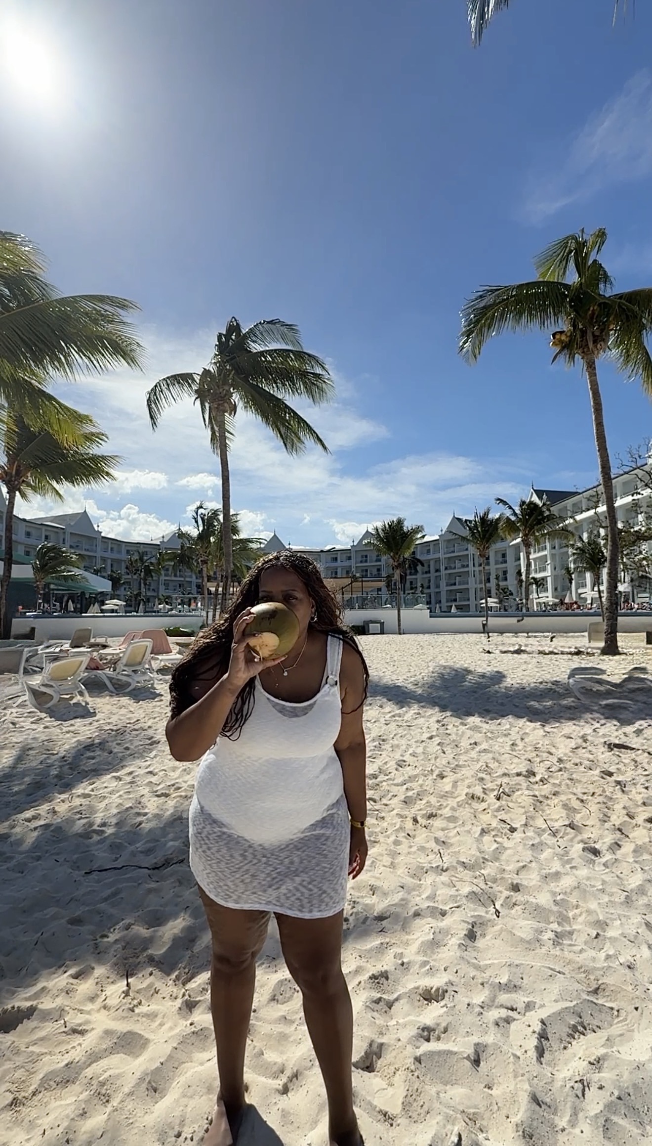 Lori drinking a coconut at Riu Ocho rios